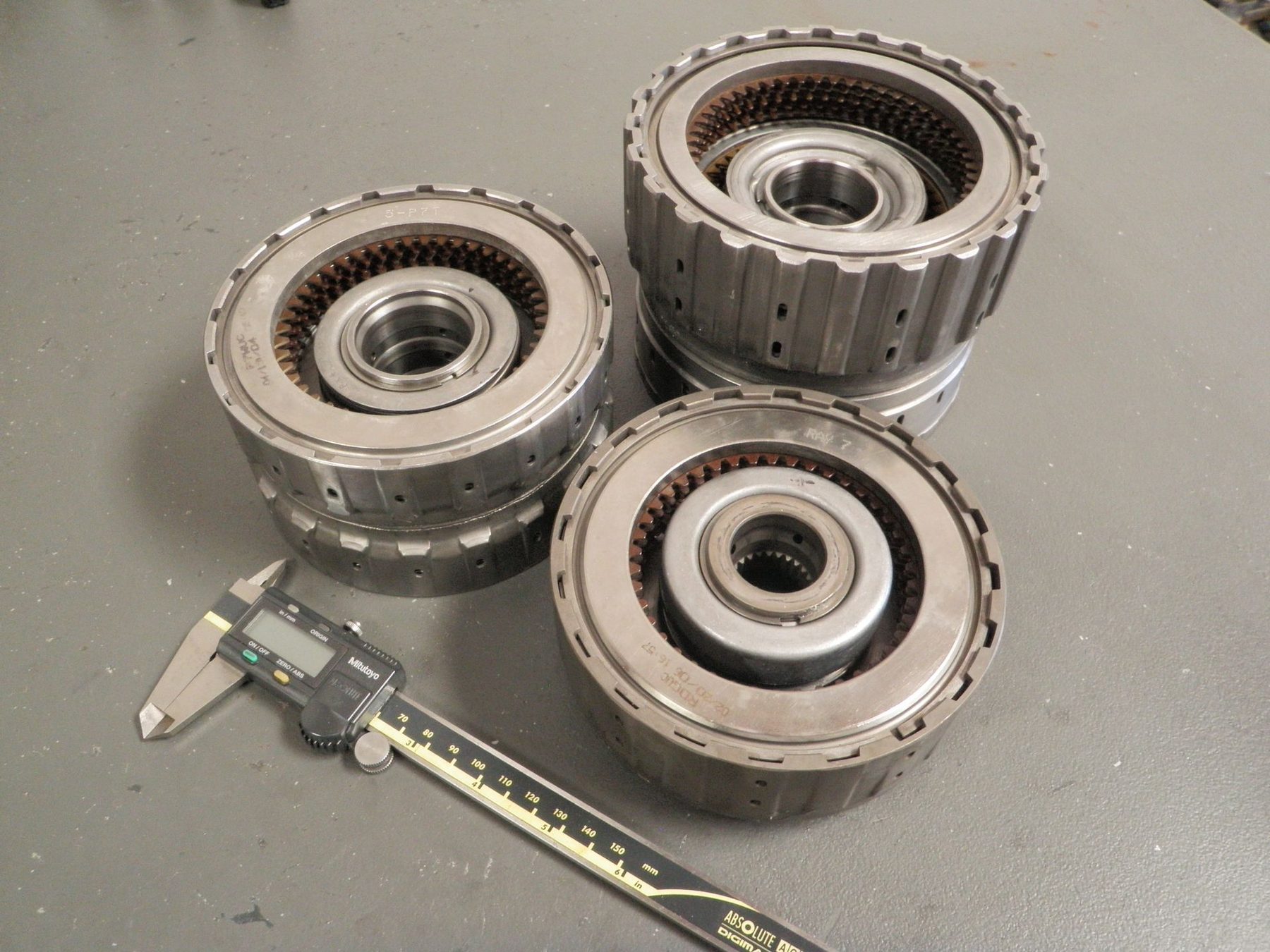 Honda transaxle clutch drums measured with digital calipers on the bench