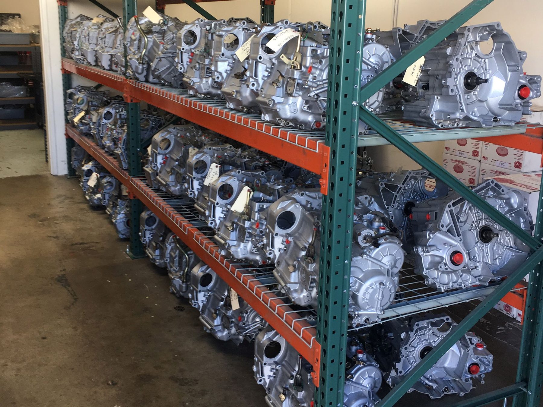 Pallet racking filled with remanufactured Honda and Acura transmissions inside the Corona facility